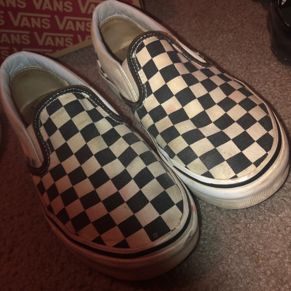 Slip on checkerboard vans.